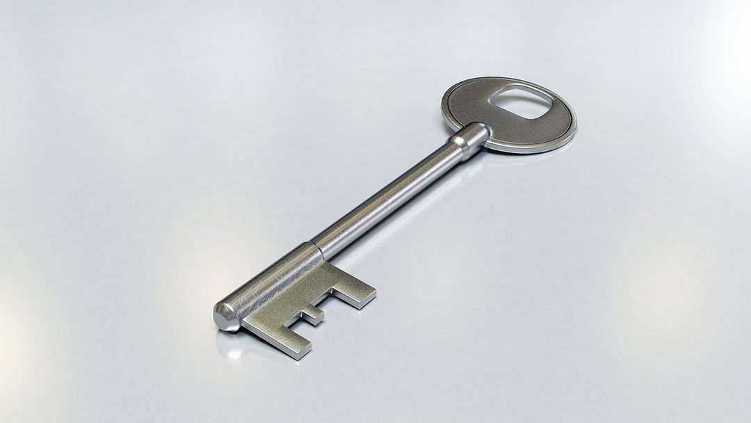 Silver key on a blank background