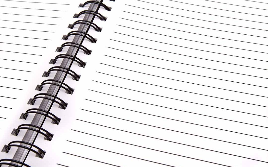 Spiral-bound lined notebook laying open